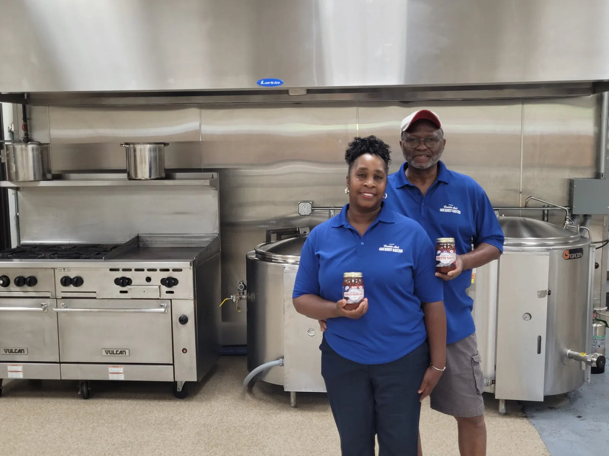 Deborah and Freddie with the cooking kettles in their Carr Street plant